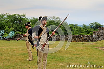 Men dressed as soldiers,reenacting musket use,Fort Ticonderoga,New York,2014 Editorial Stock Photo