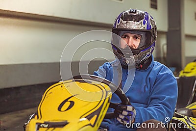 Men driving kart car with speed in a playground racing track Stock Photo
