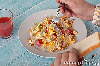 Men eating breakfast scrambled eggs Stock Photo