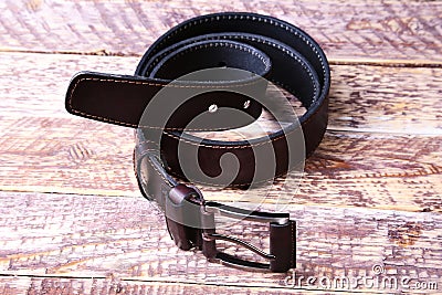 Men elegance leather belt on wooden table. Stock Photo