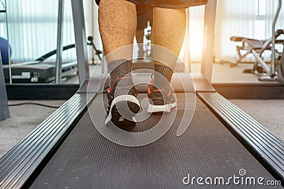 Men are exercising by running on a treadmill after working in an activity indoor fitness center as a healthy body. concept sport Stock Photo