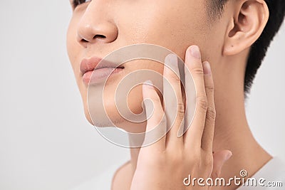 Men Face Care. Man Touching Smooth Skin After Shaving Stock Photo