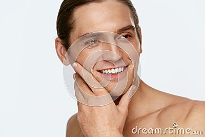 Men Face Care. Man Touching Smooth Skin After Shaving Stock Photo
