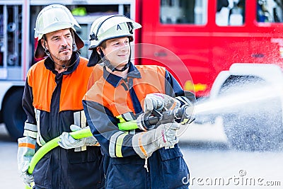 Men of the fire department extinguish fire Stock Photo