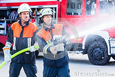 Men of the fire department extinguish fire Stock Photo