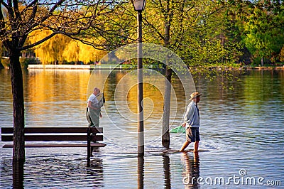 Men fish with nets in the flooded Park in Ottawa Editorial Stock Photo
