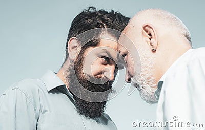 Men generations: grandfather and father together. Elderly Senior man and bearded son - two generation concept. Father Stock Photo