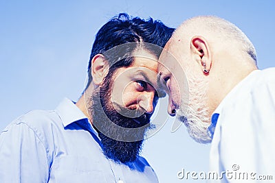 Men generations: grandfather and father together. Elderly Senior man and bearded son - two generation concept. Father Stock Photo