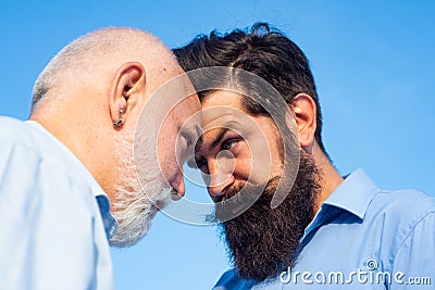 Men generations: grandfather and father together. Elderly Senior man and bearded son - two generation concept. Father Stock Photo