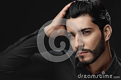 Men Hair Beauty. Handsome Male Model Touching Healthy Hair Stock Photo