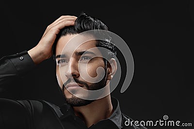 Men Hair Care. Man With Beard, Beauty Face Touching Black Hair Stock Photo