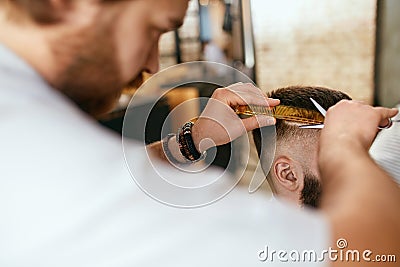 Men Haircut. Barber Cutting Man`s Hair In Barber Shop Stock Photo