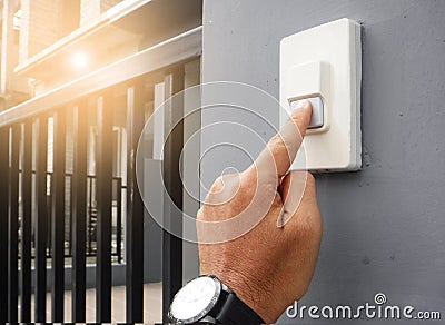 Hands press the doorbell. Stock Photo