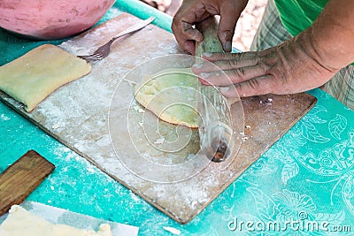 Men hands rolls dough closeup outdoors, cook on camp. Concept of homemade cooking Stock Photo