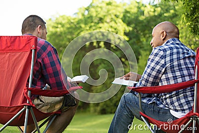 Multi-Ethnic group of friends talking and having a bible study. Stock Photo