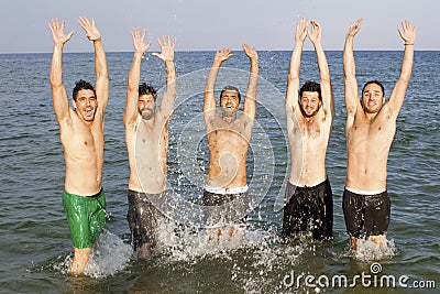 Men having fun on the beach Stock Photo