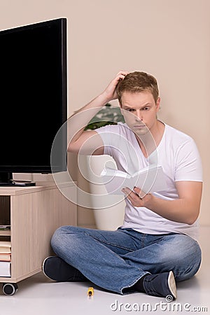 Men with instruction manual. Stock Photo