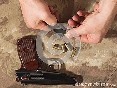 Men load ammo in the clip Makarov pistol Stock Photo