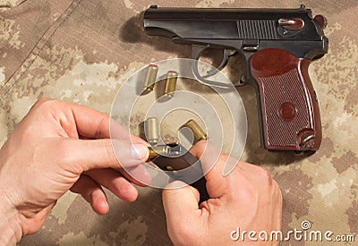 Men load ammo in the clip Makarov pistol Stock Photo