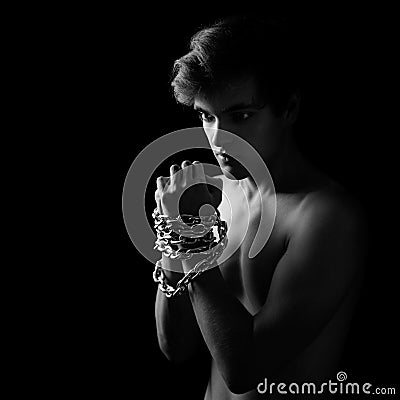 Men locked in metal chain on black background Stock Photo