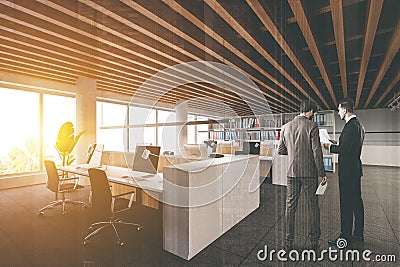 Men in loft open space office with meeting room Stock Photo