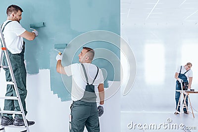 Men painting empty home interior Stock Photo