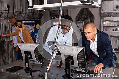 Men in panic looking for a solution on the computer in quest room Stock Photo