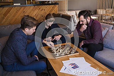Men play chess in a stylish loft cafe with a modern design Stock Photo
