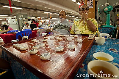 Men play Chinese chess in Chinatown Bangkok. Editorial Stock Photo