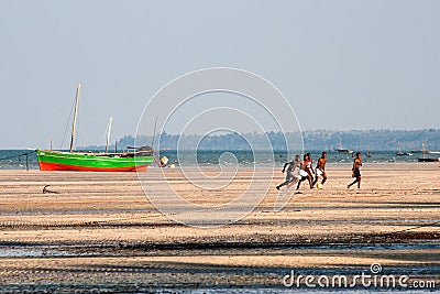 Men play soccer at the beach in Mozambique. Editorial Stock Photo