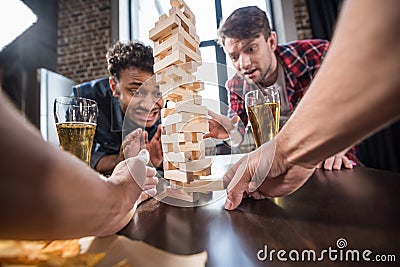 Men playing jenga game Stock Photo