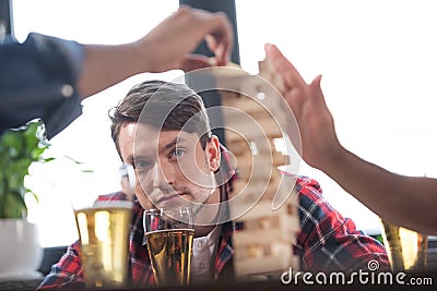 Men playing jenga game Stock Photo