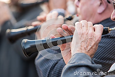 Men playing a typical wind instrument of the celebration of the Fallas of Valencia, called Editorial Stock Photo