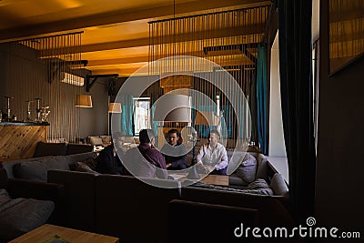 Men relax and smoke hookah in a stylish loft cafe with a modern design Stock Photo