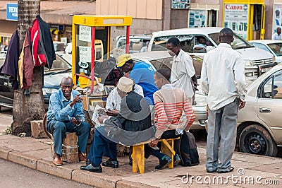 Men relaxing on Entebbe Road, Kampala Editorial Stock Photo
