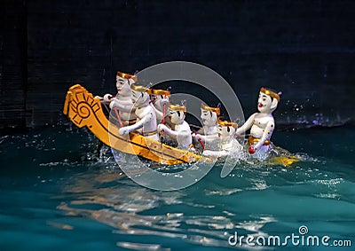 Men rowing a boat water puppets in the Thang Long Water Puppet Theatre, Hanoi, Vietnam Editorial Stock Photo