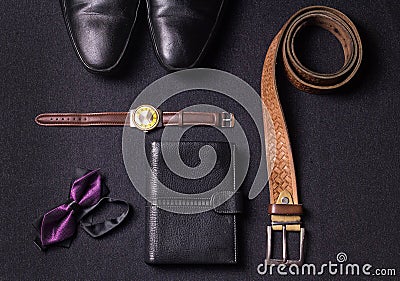 Men`s accessories on black background tie wallet watch strap sho Stock Photo