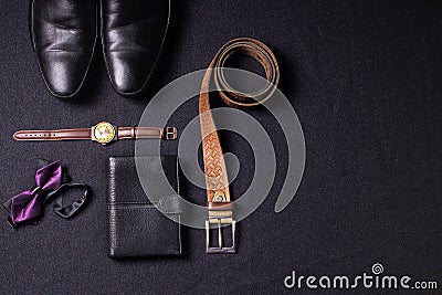 Men`s accessories on black background tie wallet watch strap sho Stock Photo