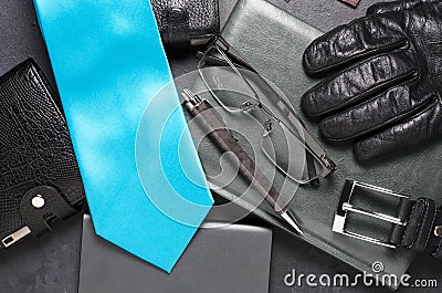 Men`s accessories and clothing on a black concrete background. The concept of the image of a modern successful man Stock Photo