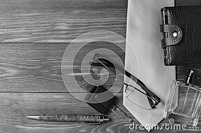 Men`s accessories and necktie on a wooden background. The concept of the image of a modern successful person. Copy space Stock Photo