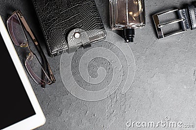Men`s accessories and tablet on a black concrete background. The concept of the image of a modern successful man. Copy space Stock Photo