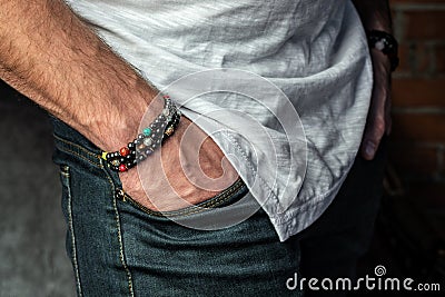 Men`s bracelets made of natural stones and minerals, close-up, on the hand Stock Photo