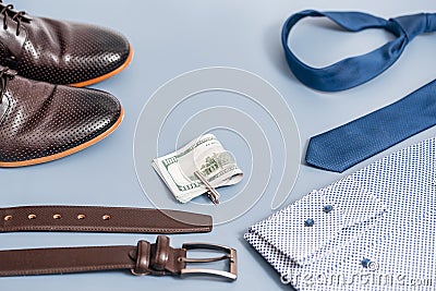 Men's clothes and accessories.tie and shoes shirt, belt money. on a blue background, copy space.Top view Stock Photo