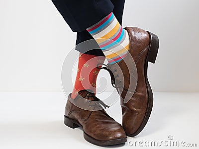 Men`s feet in stylish shoes and funny socks Stock Photo