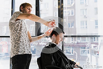 Men`s hairstyling and haircutting in a barber shop or hair salon Stock Photo