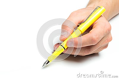 Men`s hand holding yellow fountain pen on isolated background, close up Stock Photo