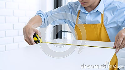 Men`s hands hold a measuring tape measuring with flexible ruler for home renovation. repair, architecture and home renovation bui Stock Photo