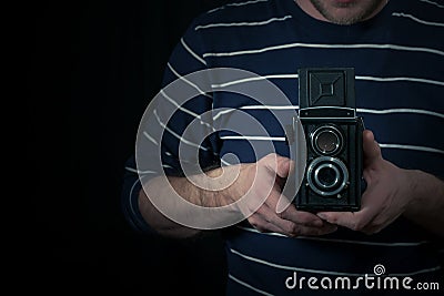 Male hand hold a medium format camera Stock Photo