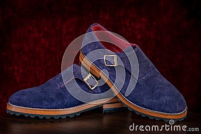 Men`s leather blue loafers on red background. Stylish men`s shoes Stock Photo