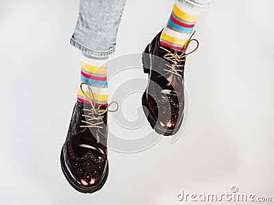 Men's legs in bright, striped, multi-colored socks Stock Photo